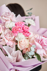 Young woman making fashion modern bouquet in korean style of different flowers. colorful color mix flower. Floral shop concept. Flowers delivery