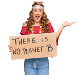 Young blonde girl wearing hippie style holding there is no planet b banner celebrating victory with happy smile and winner expression with raised hands