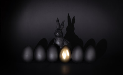 black easter, black eggs and golden egg, black rabbit