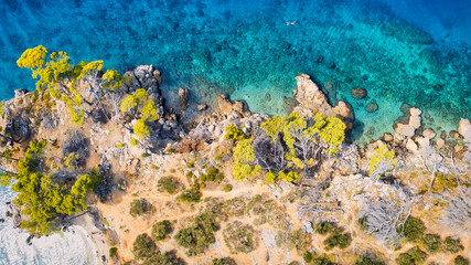 Fototapeta na wymiar Take in the beauty of Croatia's coastal region from a new perspective with this stunning drone view, which features clear blue water and forested land.