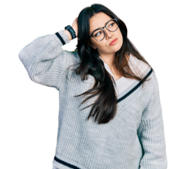 Beautiful hispanic woman wearing casual sweater and glasses confuse and wondering about question. uncertain with doubt, thinking with hand on head. pensive concept.