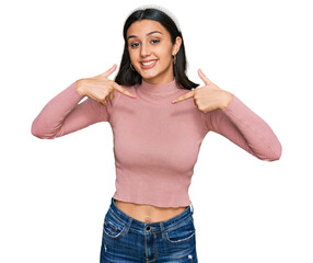 Young hispanic girl wearing casual clothes looking confident with smile on face, pointing oneself...