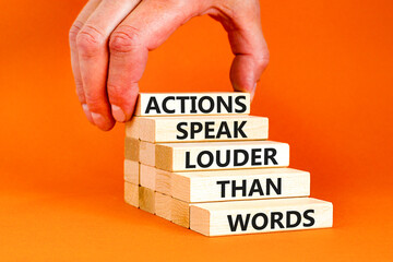 Actions speak louder words symbol. Concept words Actions speak louder than words on wooden blocks. Beautiful orange table orange background. Business new mindset for results concept. Copy space.