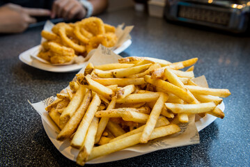 Plate full of french fries and onions rings