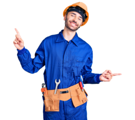 Young hispanic man wearing worker uniform smiling confident pointing with fingers to different directions. copy space for advertisement