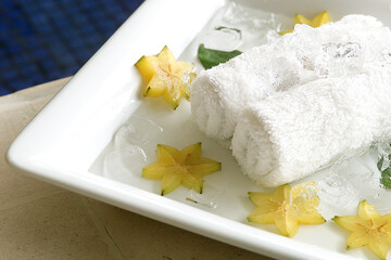 Spa towels dipped in ice and carambola fruit, refreshing