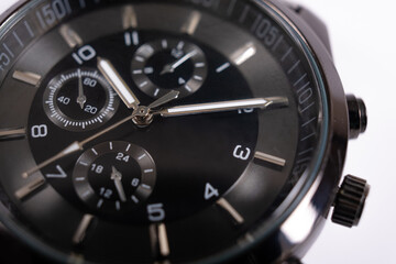 Classic luxury modern men's wrist watch. Mordern black wristwatch on white background. Chronograph close up scene