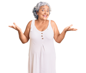 Senior woman with gray hair wearing casual clothes clueless and confused expression with arms and hands raised. doubt concept.