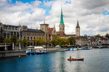 Zurich, view over Limmat River from quaibrucke bridge, Quay Bridge over the river Limmat at the outflow of Lake Z&uuml;rich; city waterfront and pier on a summer cloudy day; old European architecture
