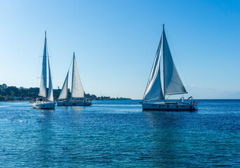 Fototapeta premium boats and yachts at the sailing regatta on open water. Sailing on the wind waves in the sea.