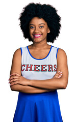 Fototapeta na wymiar Young african american woman wearing cheerleader uniform happy face smiling with crossed arms looking at the camera. positive person.