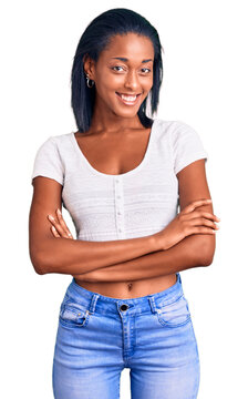 Young african american woman wearing casual clothes happy face smiling with crossed arms looking at the camera. positive person.
