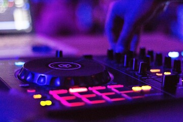 Obraz na płótnie Canvas dj hand playing the mixing console in nightclub