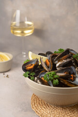 Delicious seafood mussels with with sauce and parsley. Lemon slices. Clams in the shells.
