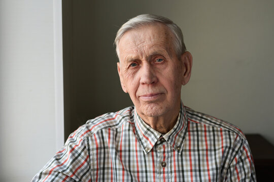 Portrait of a serious nice old man, 80 years old, looking at the camera.