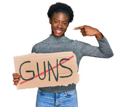 Young african american girl holding no guns warning banner pointing finger to one self smiling happy and proud