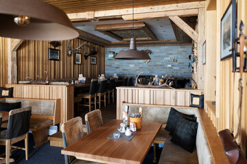 Interior of the Alpine restaurant, decorated in the national style with wood and stone, Austria