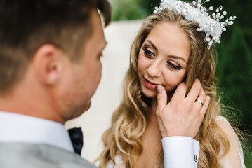 The bride and groom. First meeting. Newlyweds standing on the terrace, balcony, backyard. Outdoors. Happy wedding day of marriage.