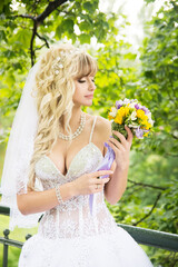 Sensual sexy bride in white dress with flower bouquet.