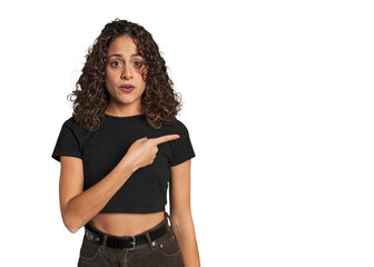 Radiant young woman with stunning curls pointing to the side