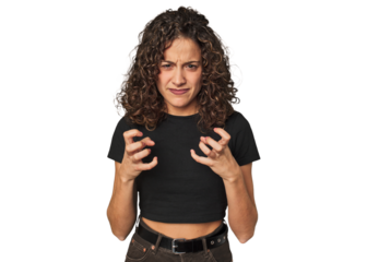 Radiant young woman with stunning curls upset screaming with tense hands.