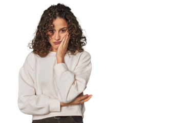 Radiant young woman with stunning curls who is bored, fatigued and need a relax day.