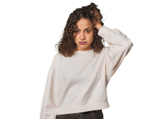 Radiant young woman with stunning curls tired and very sleepy keeping hand on head.