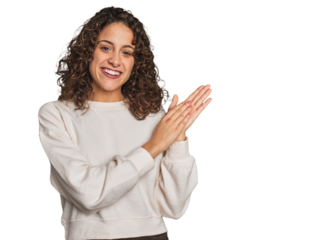 Radiant young woman with stunning curls feeling energetic and comfortable, rubbing hands confident.