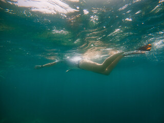 woman snorkeling in clear tropical sea