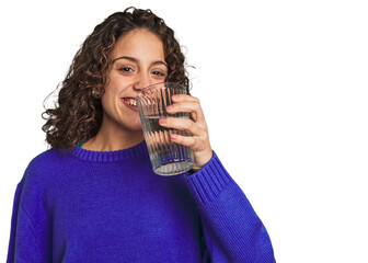 A young caucasian woman with athletic build and sportswear holding a glass of water in her hand,...
