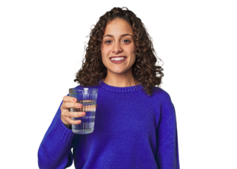 A young caucasian woman with athletic build and sportswear holding a glass of water in her hand, taking a refreshing break and promoting healthy hydration habits.