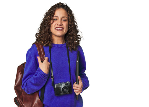 Joyful digital nomad with vintage camera and laptop.