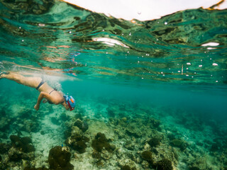 woman snorkeling in clear tropical sea