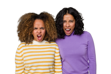 Two female friends isolated in studio screaming very angry and aggressive.