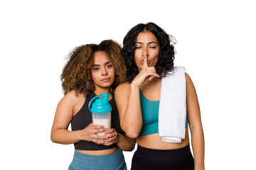Two best friends are ready to go to the gym, one of them holds a protein shake, keeping a secret or asking for silence.