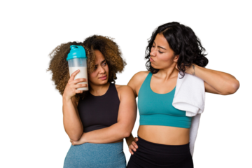 Two best friends are ready to go to the gym, one of them holds a protein shake, touching back of head, thinking and making a choice.