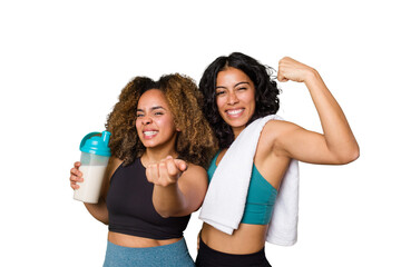 Two best friends are ready to go to the gym, one of them holds a protein shake, pointing with finger at you as if inviting come closer.