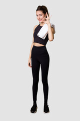 Full body of young woman in sportswear, fit and athletic, embodying a healthy and active lifestylecheerful and confident showing ok gesture.