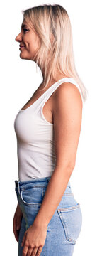 Young beautiful blonde woman wearing casual sleeveless t-shirt looking to side, relax profile pose with natural face with confident smile.