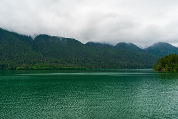 tranquil lake with clouds and fog