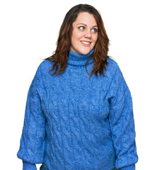 Young plus size woman wearing casual clothes looking away to side with smile on face, natural expression. laughing confident.