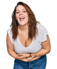 Young plus size woman wearing casual white t shirt smiling and laughing hard out loud because funny...