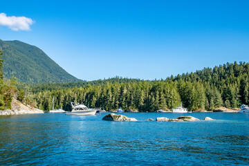 Fototapeta na wymiar Desolation Sound Yacht Boat Near Mountains in Summer on Strait of Georgia in Vancouver Island, British Columbia, Canada