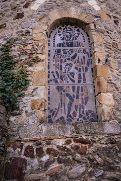 Exterior vertical stained glass window of church in Laval, France, Mayenne.