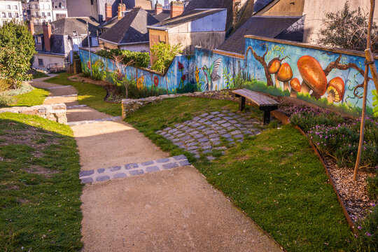 Colorful graffiti along walkway in park in Laval France on the Mayenne River