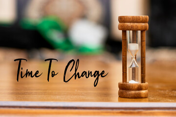 Time to change concept with hourglass on wood table as time passing concept. Life time passing....