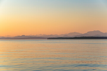Beautiful Sunset With Hazy Mountains on Strait of Georgia in Vancouver Island , British Columbia, Canada
