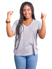 Young african american woman with braids wearing casual clothes screaming proud, celebrating...