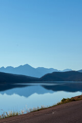 Mountain Reflections: Majestic Range Creates a Mesmerizing Mirror on the Lake's Calm Surface