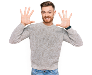 Young redhead man wearing casual winter sweater showing and pointing up with fingers number ten while smiling confident and happy.